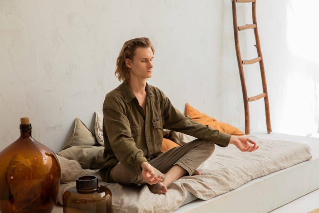 Man is relaxing and meditating to release stress caused from OCD and anxiety.