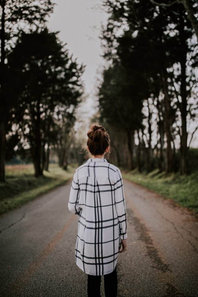 Woman walking alone trying to figure out how she will start using personal growth.