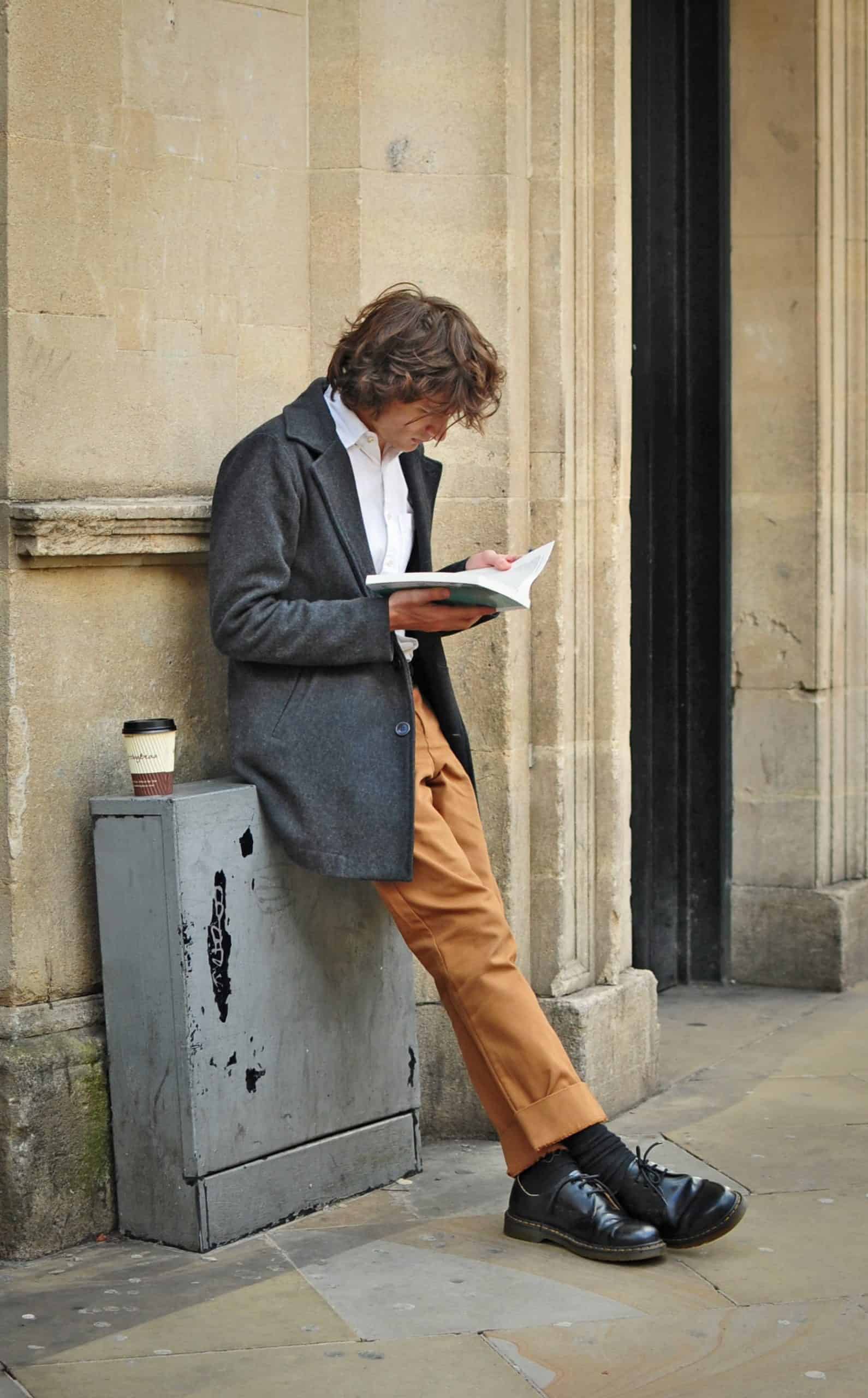 A man reading a book in hopes of developing a growth mindset
