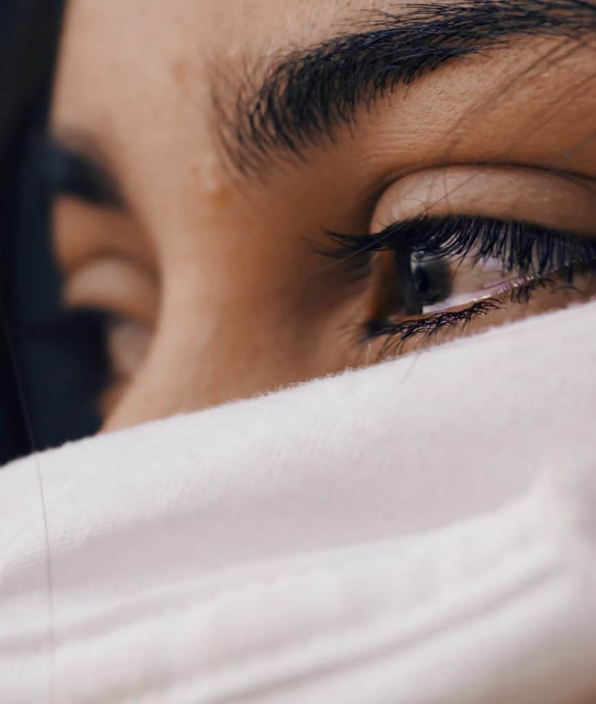 A woman crying due to gender differences in OCD.